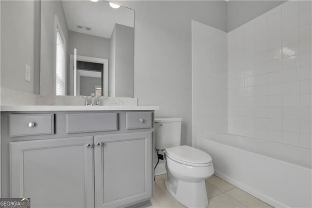 bathroom featuring vanity, tile patterned flooring, and toilet