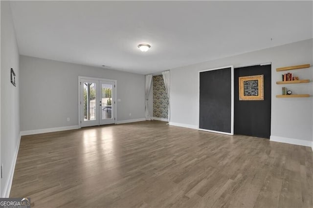 unfurnished room featuring hardwood / wood-style flooring and french doors