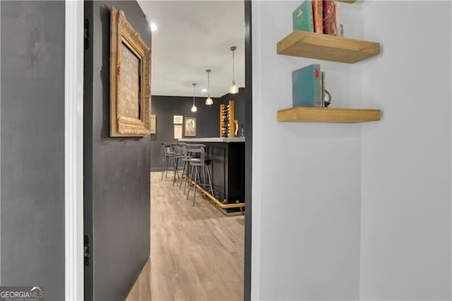 hallway with light hardwood / wood-style floors