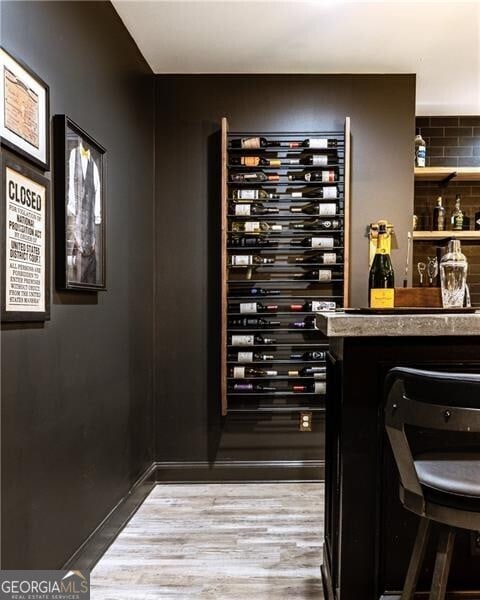 wine area with light hardwood / wood-style flooring