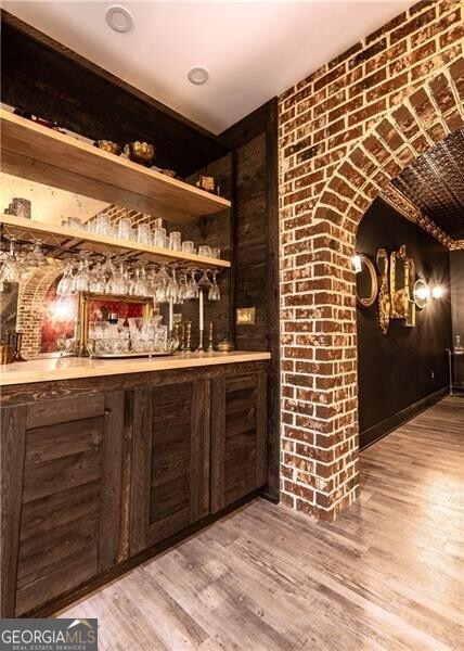 bar with light hardwood / wood-style flooring