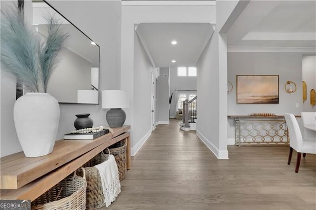 entryway with crown molding and wood-type flooring