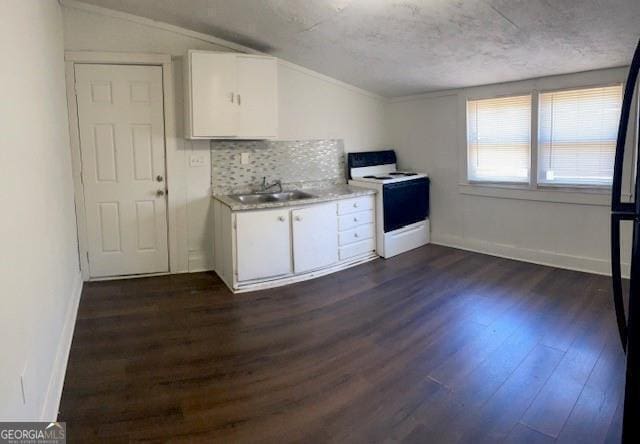 kitchen featuring white cabinets, white range with electric stovetop, lofted ceiling, and sink