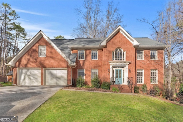 view of front of property featuring a front yard and a garage