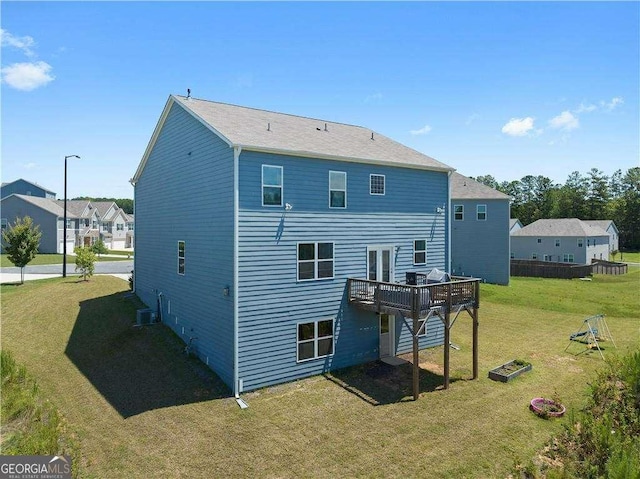 back of house with a deck and a yard