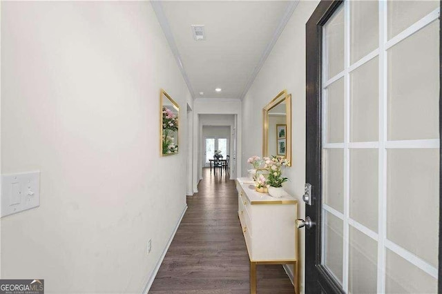 hallway with french doors, dark wood-type flooring, and crown molding