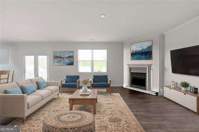 living room featuring dark hardwood / wood-style flooring and ornamental molding