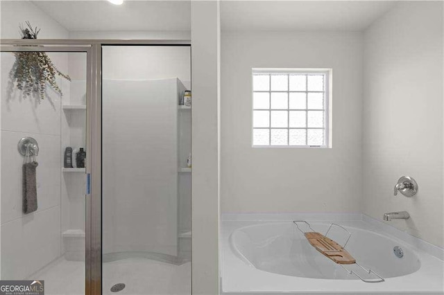 bathroom featuring separate shower and tub