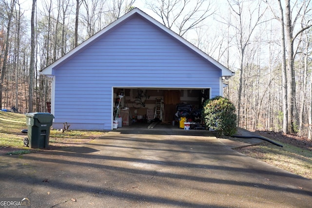 view of home's exterior with a garage and an outdoor structure