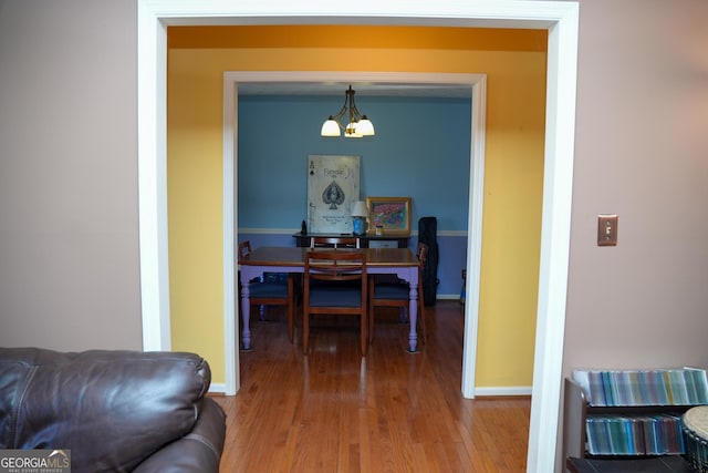 dining area featuring a notable chandelier and hardwood / wood-style flooring