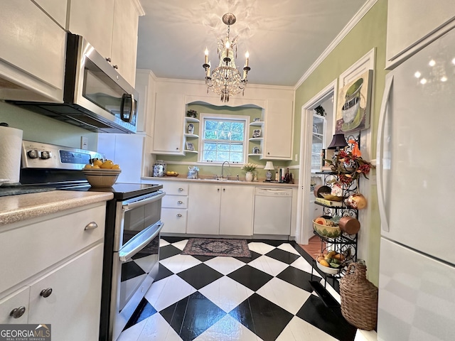 kitchen featuring pendant lighting, white cabinetry, ornamental molding, and appliances with stainless steel finishes