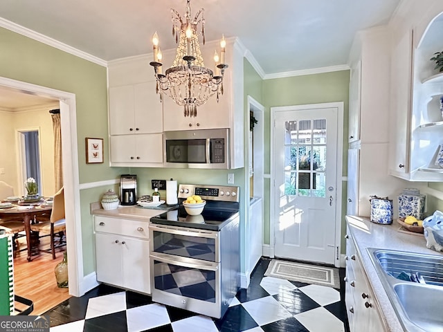 kitchen with pendant lighting, stainless steel appliances, crown molding, and white cabinets