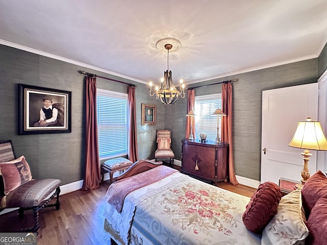 bedroom featuring crown molding, wood-type flooring, and an inviting chandelier