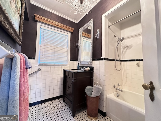 bathroom with washtub / shower combination, tile walls, an inviting chandelier, vanity, and ornamental molding