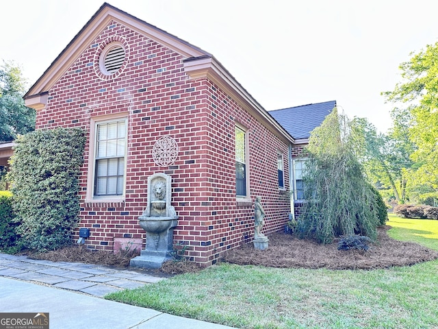 view of side of home with a lawn