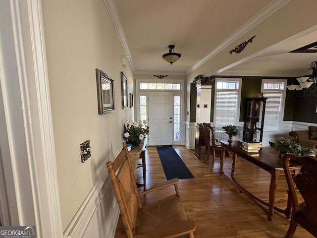 foyer featuring crown molding and dark hardwood / wood-style floors