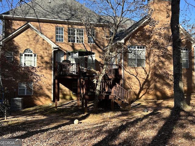 rear view of house featuring central AC unit and a deck