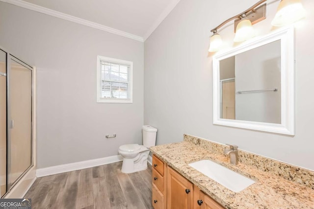 bathroom with wood-type flooring, toilet, a shower with door, vanity, and ornamental molding