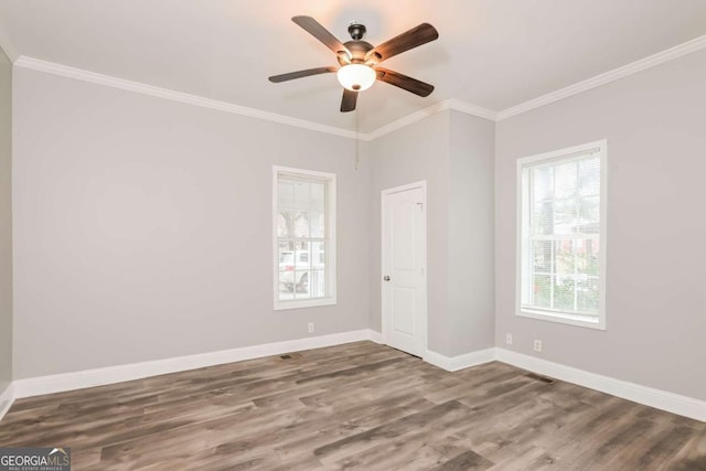 empty room featuring ceiling fan, wood-type flooring, and crown molding