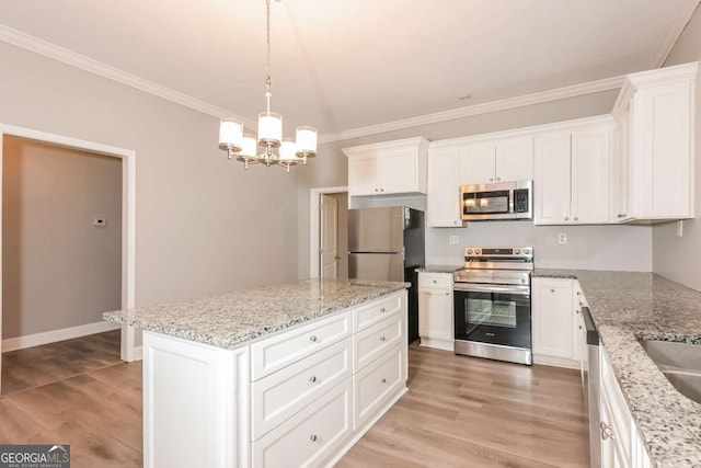 kitchen with white cabinets, a kitchen island, stainless steel appliances, and wood-type flooring