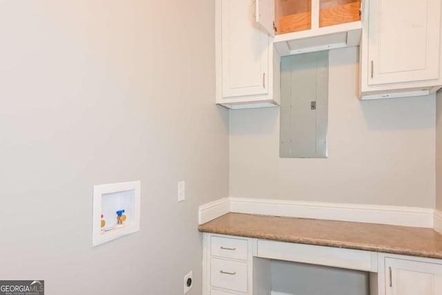 laundry room featuring electric dryer hookup, electric panel, cabinets, and washer hookup