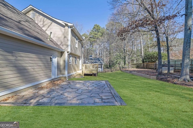 view of yard featuring a patio area and a deck