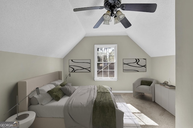 bedroom featuring lofted ceiling, a ceiling fan, a textured ceiling, and light colored carpet