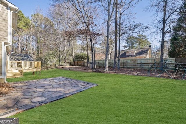 view of yard with a fenced backyard and a wooden deck