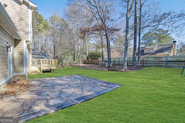 view of yard featuring a deck and a patio area