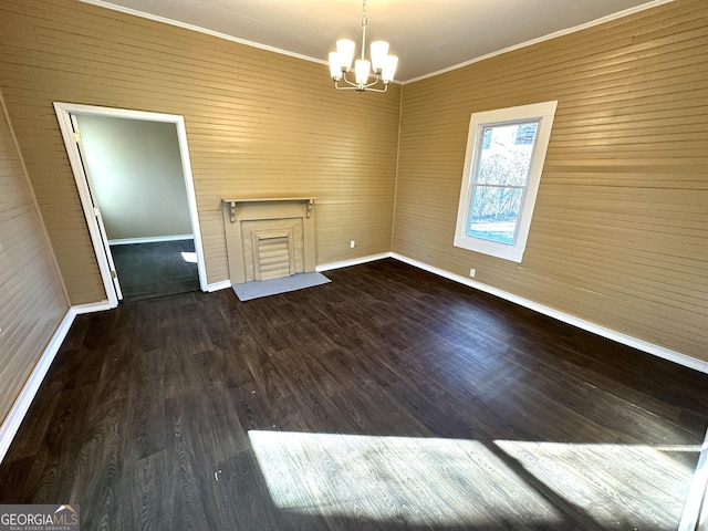 interior space with hardwood / wood-style floors, ornamental molding, and an inviting chandelier