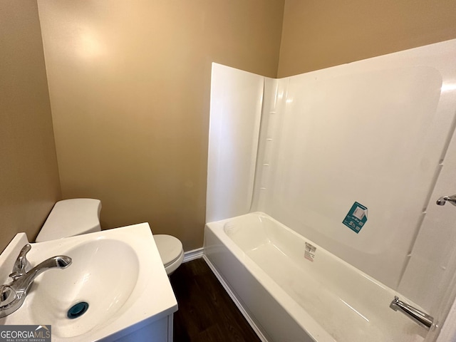 bathroom with hardwood / wood-style flooring, vanity, and toilet