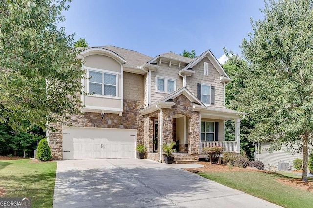 craftsman house with a front lawn, central AC unit, a porch, and a garage