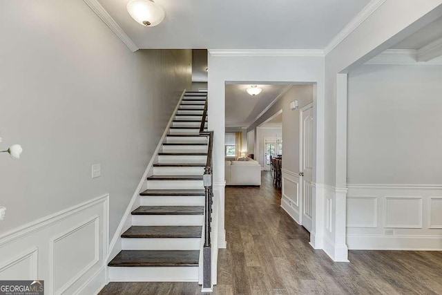 stairway featuring hardwood / wood-style floors and ornamental molding