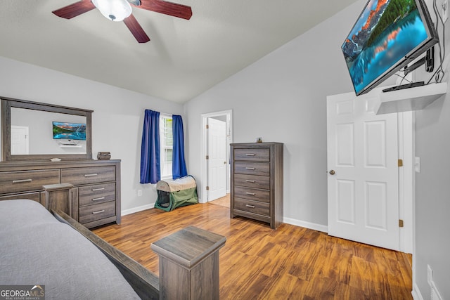 bedroom featuring hardwood / wood-style flooring, vaulted ceiling, and ceiling fan