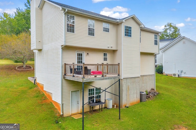 rear view of property featuring a balcony and a lawn