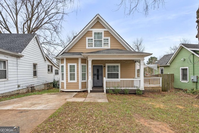 bungalow with a front lawn and covered porch