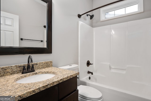 full bathroom featuring bathing tub / shower combination, vanity, and toilet