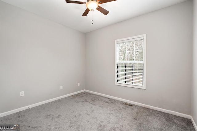 carpeted spare room featuring ceiling fan