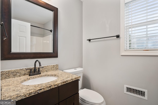 bathroom featuring vanity and toilet