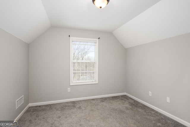 bonus room featuring vaulted ceiling and carpet