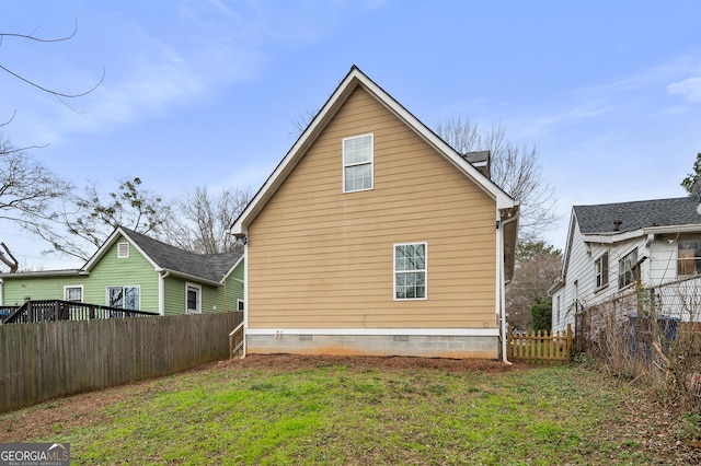 back of property featuring a lawn