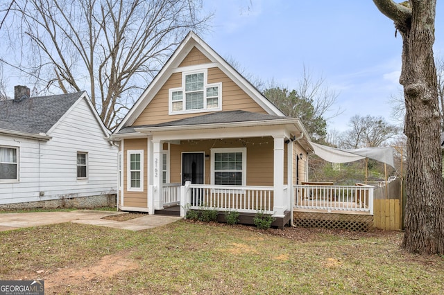 bungalow-style house with a porch and a front lawn