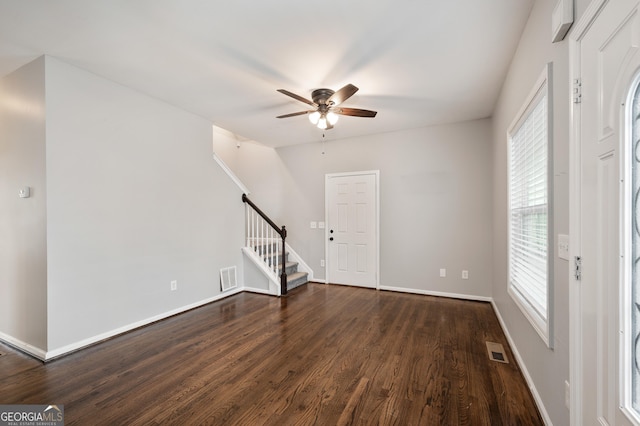 interior space featuring dark wood-type flooring and ceiling fan