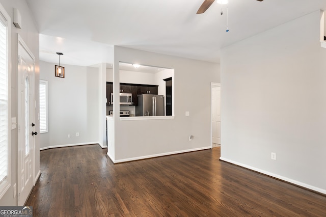 unfurnished living room with dark wood-type flooring and ceiling fan