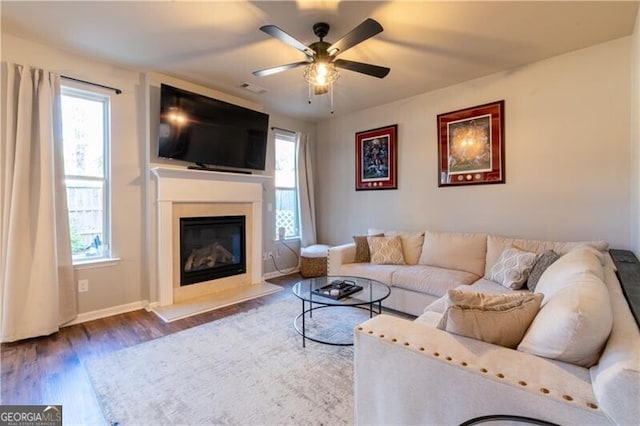 living room with hardwood / wood-style floors and ceiling fan