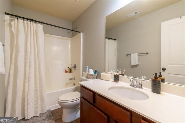 full bathroom with vanity, toilet, and shower / bathtub combination with curtain