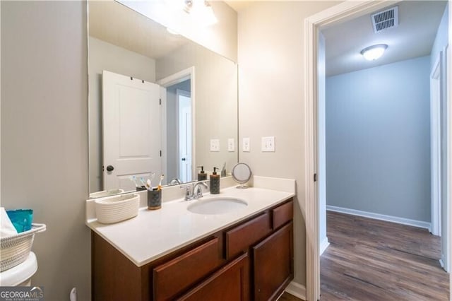 bathroom featuring hardwood / wood-style flooring and vanity