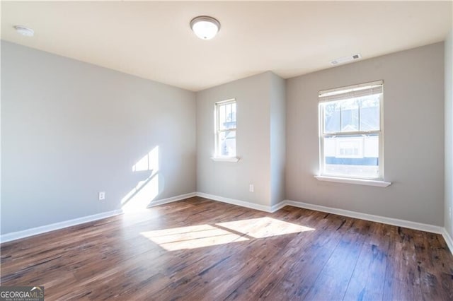 empty room featuring dark wood-type flooring