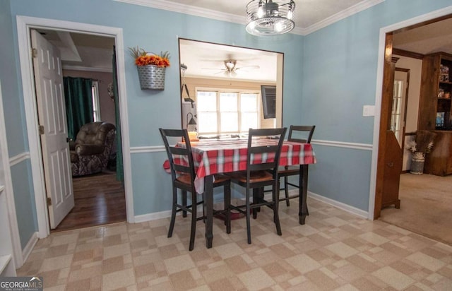 dining space with ceiling fan and ornamental molding