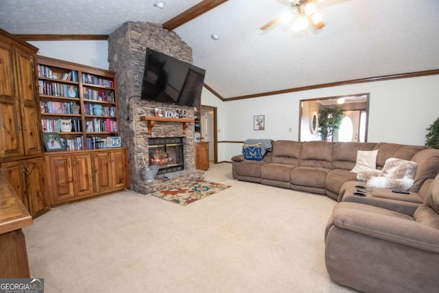 carpeted living room featuring vaulted ceiling with beams, a stone fireplace, ceiling fan, and ornamental molding